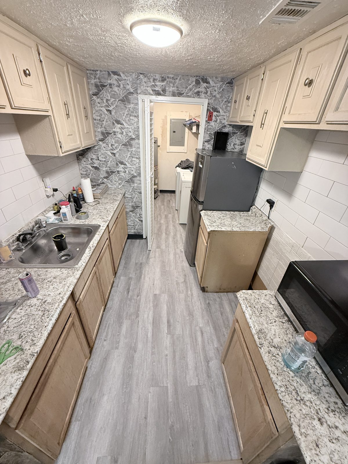 Finished gray kitchen flooring after restoration