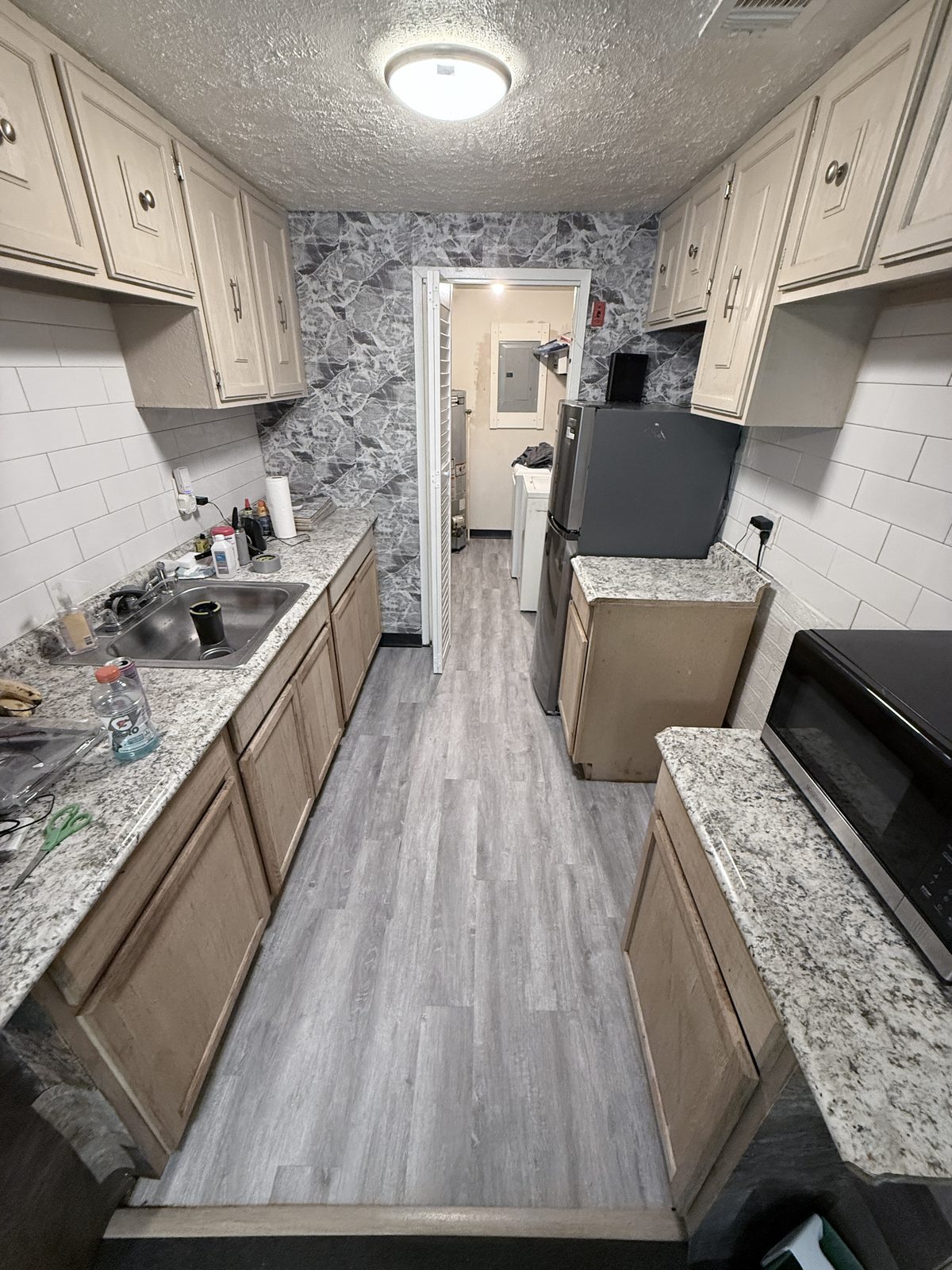 Finished gray kitchen flooring after restoration