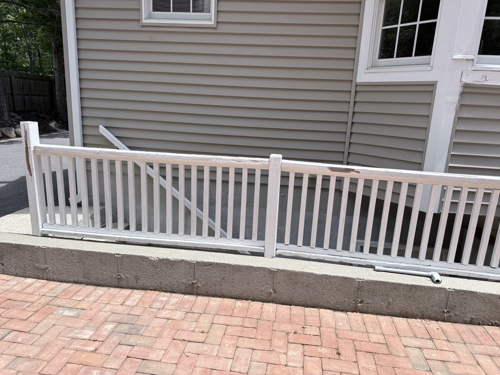 Old white exterior railing before replacement